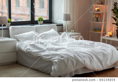 cozy bedroom with white linen on bed 69134854