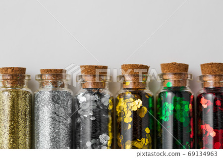 set of glitters in bottles over white background 69134963