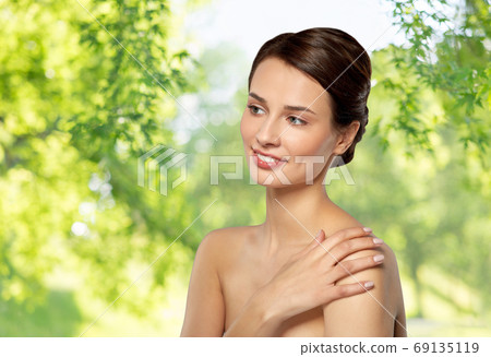 beautiful young woman touching bare shoulder beautiful young woman touching bare shoulder 69135119