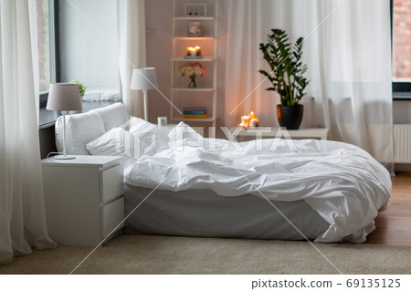 cozy bedroom with white linen on bed 69135125