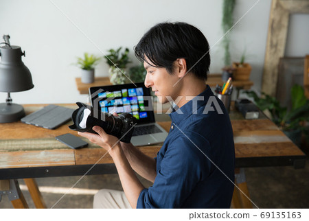 Photographer working at desk 69135163