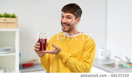 happy man with tomato juice in takeaway cup happy man with tomato juice in takeaway cup 69135339