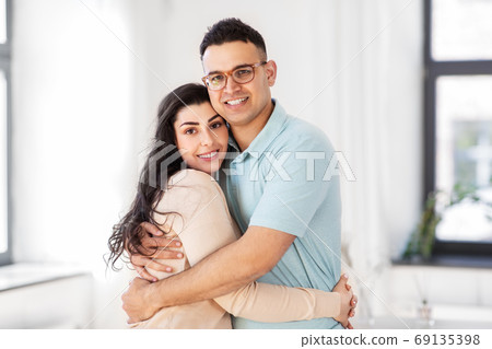 happy couple hugging at home happy couple hugging at home 69135398