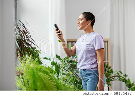 african american woman with smartphone at home 69135482