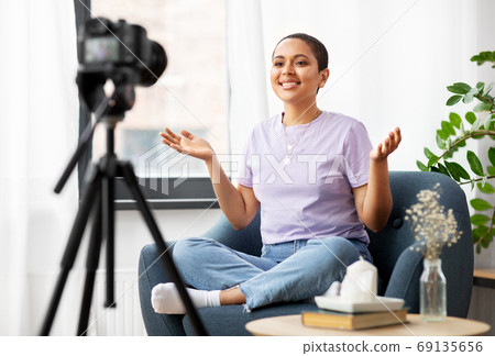 female blogger with camera video blogging at home female blogger with camera video blogging at home 69135656