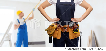 woman or builder with working tools on belt woman or builder with working tools on belt 69135657
