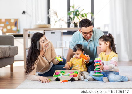 happy family palying with wooden toys at home 69136347
