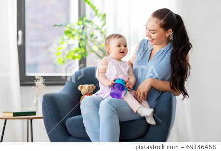 happy mother with little baby daughter at home happy mother with little baby daughter at home 69136468