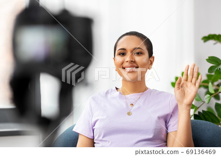 female blogger with camera video blogging at home female blogger with camera video blogging at home 69136469
