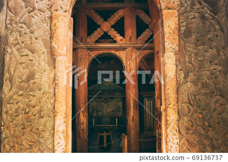 Borgund, Norway. Carved Details Of Famous Wooden Norwegian Landmark Stavkirke. Ancient Old Wooden Triple Nave Stave Church Borgund, Norway. Carved Details Of Famous Wooden Norwegian Landmark Stavkirke. Ancient Old Wooden Triple Nave Stave Church 69136737
