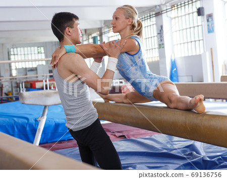 Man coaching woman in gym Man coaching woman in gym 69136756