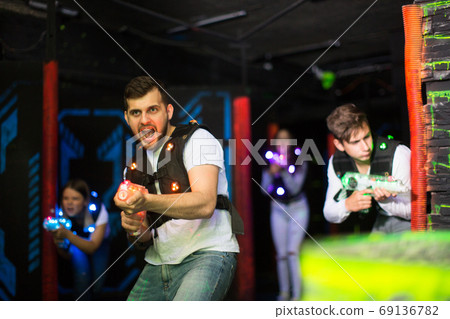Young man on laser tag arena Young man on laser tag arena 69136782
