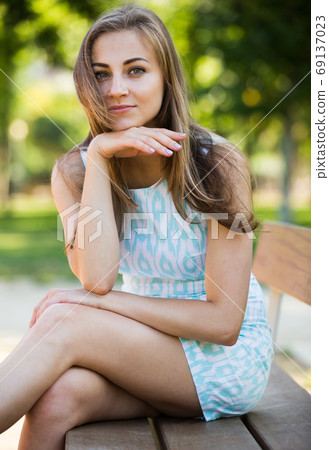 portrait of positive young female portrait in garden 69137023