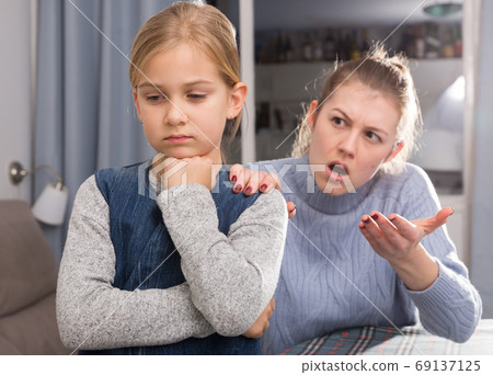 Dissatisfied mother scolds little girl Dissatisfied mother scolds little girl 69137125