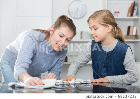 Mother and daughter cleans the house Mother and daughter cleans the house 69137232