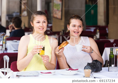 female friends traveling and drinking tea with bakery in lunch female friends traveling and drinking tea with bakery in lunch 69137234