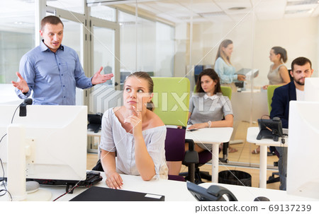 Irritated boss scolding female subordinate Irritated boss scolding female subordinate 69137239