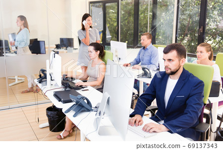 Group of successful business people during daily work in modern co-working space Group of successful business people during daily work in modern co-working space 69137343