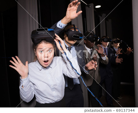 Scared girl taking off vr glasses Scared girl taking off vr glasses 69137344