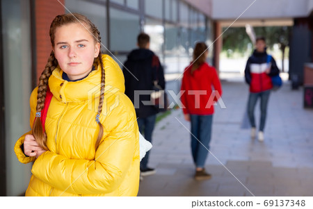 Female teenage student on her way to college Female teenage student on her way to college 69137348