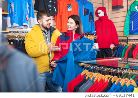 Couple choosing jacket in store Couple choosing jacket in store 69137441