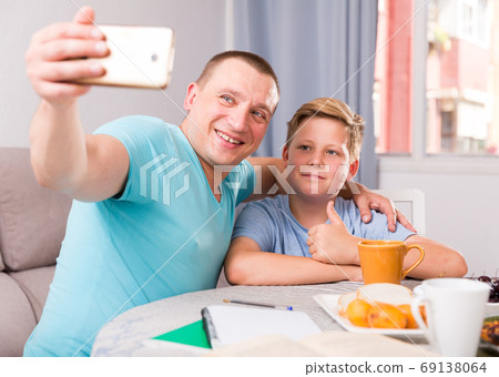 Man with his son are taking selfie together Man with his son are taking selfie together 69138064