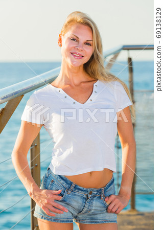 Elegant woman is posing on pirce in her free time Elegant woman is posing on pirce in her free time 69138129