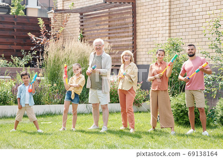 Family Posing With Water Guns 69138164