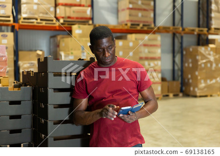 Portrait of afro man worker in warehouse Portrait of afro man worker in warehouse 69138165