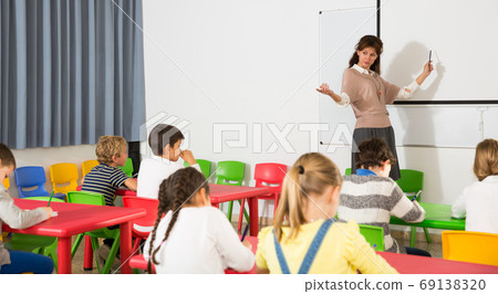 Teacher with children during lesson Teacher with children during lesson 69138320