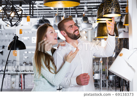 couple choosing suspension lamp 69138373