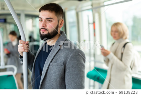 Portrait of modern male passenger traveling in bus 69139228