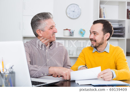Adult man and agent discuss contract 69139409
