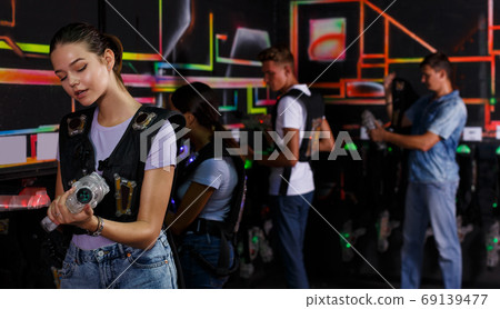 people looking laser guns and clothes together 69139477