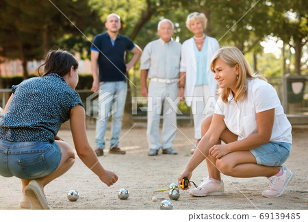 Happy family playing petanque in outdoor Happy family playing petanque in outdoor 69139485