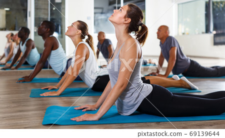 People doing stretching exercises 69139644