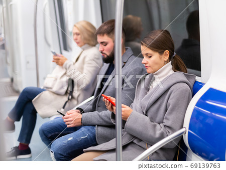 Girl with phone in metro car 69139763