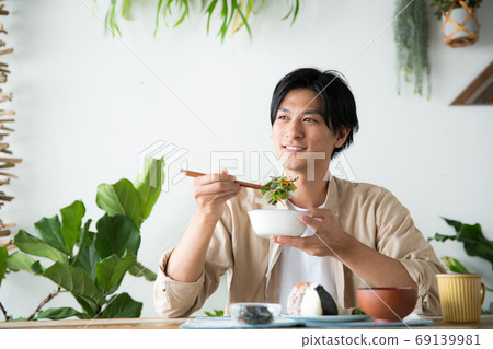 Men eating breakfast in the room Men eating breakfast in the room 69139981