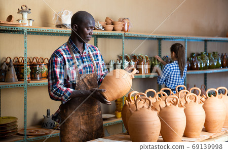 Woman and man potters in studio Woman and man potters in studio 69139998