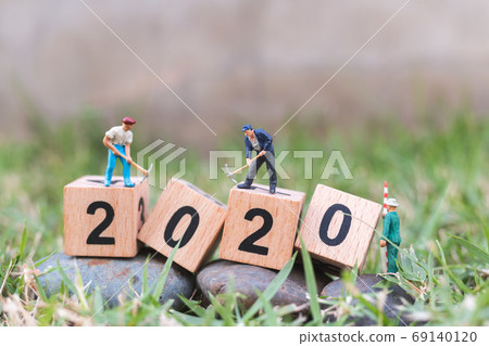 Miniature people : Worker team create wooden block number 2020 , Happy new year concept Miniature people : Worker team create wooden block number 2020 , Happy new year concept 69140120