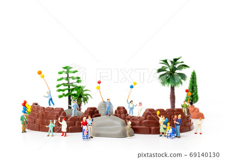 Miniature people: Happy family holding balloon in The park , World Children's Day concept Miniature people: Happy family holding balloon in The park , World Children's Day concept 69140130
