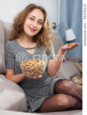 Woman holding bowl of walnuts 69140225