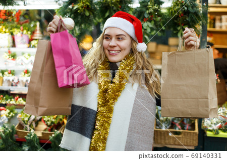 Woman holding bags with Christmas toys Woman holding bags with Christmas toys 69140331