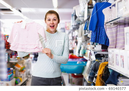 Young woman awating for baby and buying clothes 69140377