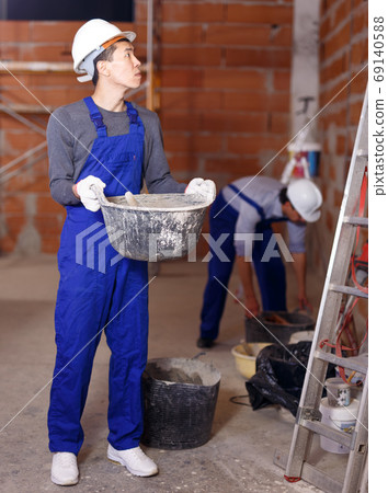 Builder in process of repair 69140588