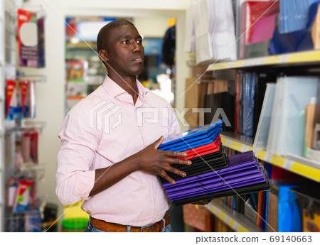 African american male customer looking documents folder African american male customer looking documents folder 69140663