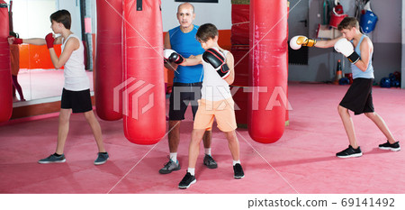Boy at boxing workout with instructor 69141492