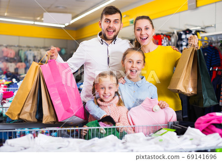 family of four with shopping bags family of four with shopping bags 69141696
