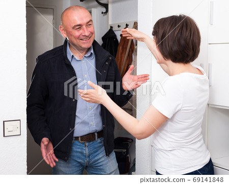 Woman meeting with her husband in the hallway at home Woman meeting with her husband in the hallway at home 69141848