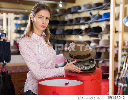 Saleswoman preparing hats in boxes for sale Saleswoman preparing hats in boxes for sale 69142042